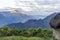 Morning landscape with Peruvian Andes mountains peaks and straw roofed small house at sunrise