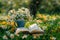 Morning leisure in garden coffee, book, flowers on lush lawn