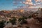 Morning LIght Brightens Distant Rocks As Trail Passes To The Right