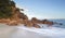 Morning light glistens on the volcanic rocks at Shoal Bay