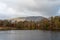 Morning light at Tarn Hows in the English Lake District with views of Yewdale Crag, and Holme Fell during autumn