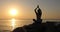 Morning meditation, woman practices yoga on the seashore, Shot on Canon EOS 5D Mark IV in Slow Motion