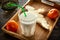 Morning milk glass. Buttermilk dairy drink breakfast on wooden desk. Tangerine, bread, butter.