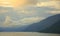 Morning on a mountain lake, clouds descend to the water, overcast