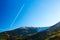 Morning Mountain View and Airplane Vapor Trail on Deep Blue Sky