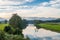 Morning nature landscape with freshwater river and mountains in the distance