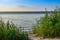 Morning panorama view over river from fishing place to opposite bank, reflection of sky in the water level