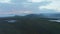 Morning panoramic footage of Nordic landscape. Vast flat green grassland with water surfaces and mountains in background