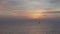 Morning pink sky reflected in the sea. A small lonely fisherman boat silhouette sailing during the sunrise. Soft color