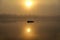 Morning. river, silhouette of a boat and fishermen, beautiful sunlight, reflection in the water of trees and the sun, a married