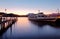 Morning scenery of Lake Lucerne at sunrise with view of a cruise ship parking by a wooden dock