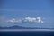 Morning at sea: Clouds and fog in a deep blue sky over Alaskan islands