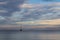 Morning seascape. Boat without sails on the ocean surface