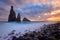 Morning seascape sunrise of Madeira. Rocky shore, silhouette of two steep cliffs and misty rocks hit by waves.