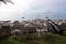 Morning seascape with yachts, thatched umbrellas on the beach, o