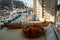 Morning in summer Provence, breakfast with fresh baked croissants and baquett bread and view on fisherman`s boats in harbour of