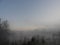 Morning sun rays peak through mist over beaver pond