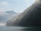 Morning sun shining through mist on the banks of Brienzersee lake, Switzerland