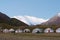 Morning Sunlight Landscape of Lenin Peak 7134m at Tourist Yurt camp of Tulpar Kol Lake in Alay Valley, Osh, Kyrgyzstan.