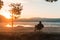 Morning and sunrise on beautiful nature. Lake and mountains. happy man sitting on chair with cup of coffee, happiness or