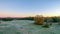 Morning sunrise over frost covered farm land