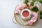 Morning tea, Cup of pink tea, booster on gold tray on white background, still life, copy space, top view, Feminine lifestyle