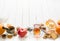 Morning tea with fruit and candied fruit. White wooden background.