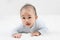 Morning Time.Adorable newborn kid during tummy time smiling happily at home.Portrait of cute smiling happy asian baby boy crawling