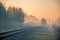 Morning train passing in the autumn haze at sunrise light