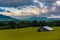 Morning view of a barn and distant mountains in the rural Potomac Highlands, West Virginia.