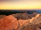 Morning view over Apine cliff and valley.Daybreak Sun at horizon. Mountains pekas