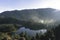 Morning view of Telaga Warna Lake with mountain background at Dieng Plateau, Central Java, Indonesia. Aerial View from Batu