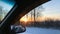 Morning winter dawn in a car window while driving