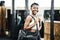 The mornings are made for the gym. an attractive young woman standing alone in the gym and holding a sports bag.