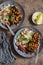 Moroccan aubergine and chickpea stew and bulgur. Healthy vegetarian lunch. On a wooden table, top view.