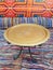 Moroccan brass table on handmade Egyptian fabrics. Round low gold table. Chill out. Gilt brass tray with iron legs. Arabic