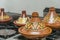 Moroccan clay tajine with different decoration on a stove in a kitchen