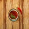 Moroccan food, tomatoe soup dish decorated with parsley, on a plate with red hot chili pepper, on a wooden table