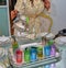 A Moroccan girl wearing a kaftan pours Moroccan tea into colorful cups.