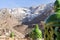 Moroccan green lantern on the top of the fence with Toubkal mountain range in Morocco