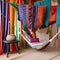 A Moroccan hammock corner with colorful hammocks, patterned pillows, and tasseled blankets4, Generative AI