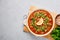 Moroccan Harira Soup in white plate on woden board on grey concrete table top. Ramadan Iftar Food