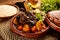 Moroccan lamb and Vegetables Tangine with bread served in a dish isolated on wooden background side view