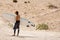 Moroccan man surfer on the beach of Sidi Kaouki, Morocco