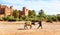 Moroccan Man Walking with Mule past Ait Benhaddou