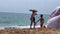 Moroccan salesman walking on the beach selling Chfenj