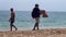 Moroccan salesman walking on the beach selling food