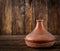 Moroccan tagine cooking vessel on a wooden table. Copy space