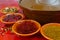 Moroccan tahine with four bowls with spices on red background