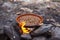 Moroccan Tajines cooked on wood fire; cooking in traditional moroccan tajine pot over open fire.